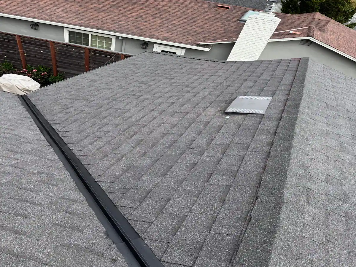 Close-up of a well-maintained gray asphalt shingle roof with vent, ready for Marin County storm season